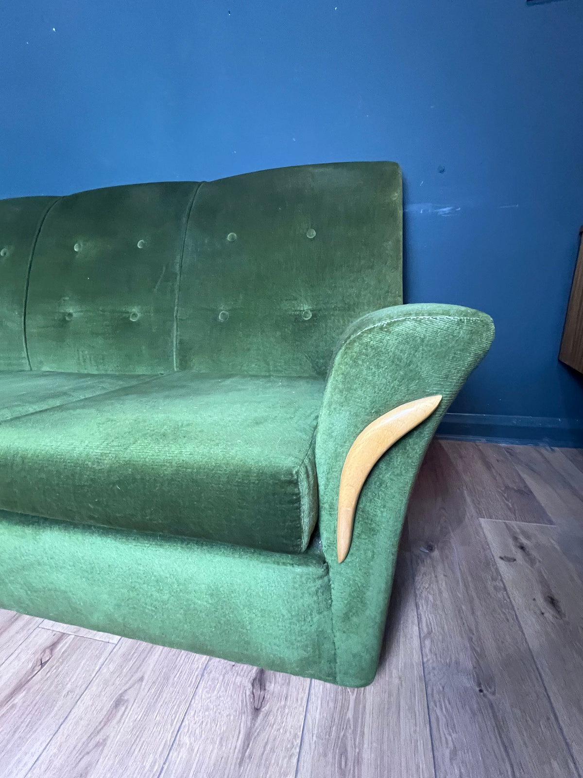 1960s moss green three seater  sofa with woodenboomerang arm detail