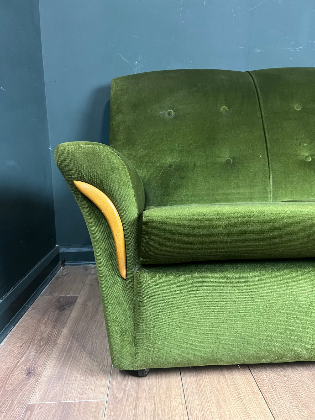 1960s moss green three seater  sofa with woodenboomerang arm detail