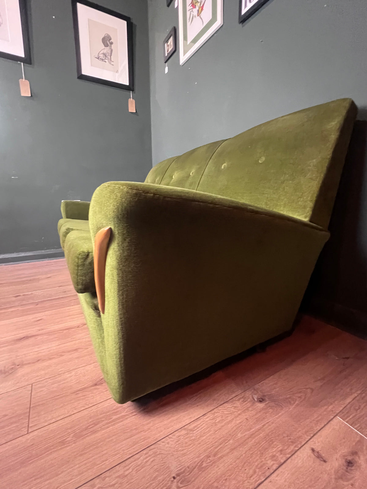 1960s moss green three seater  sofa with woodenboomerang arm detail
