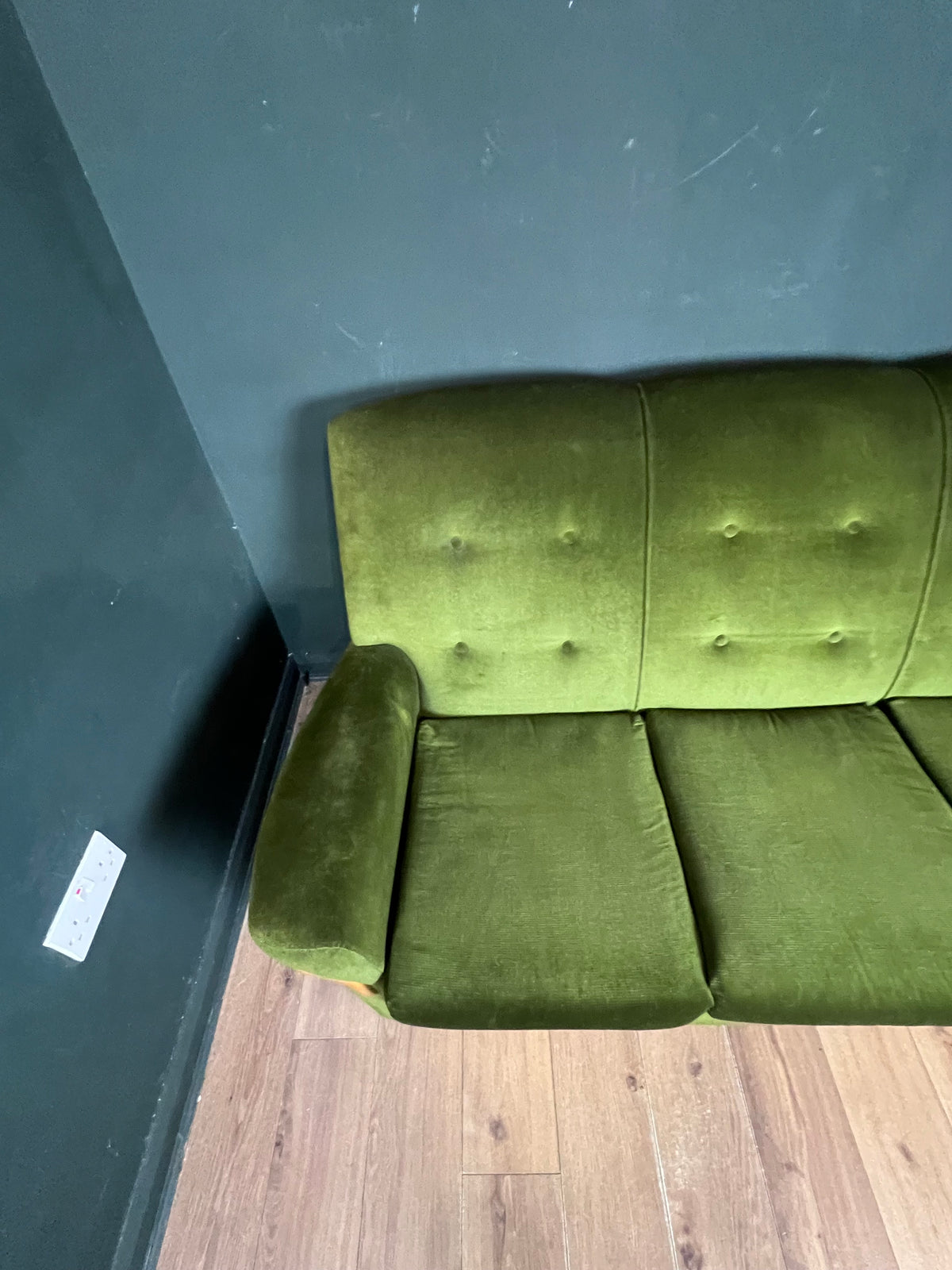 1960s moss green three seater  sofa with woodenboomerang arm detail
