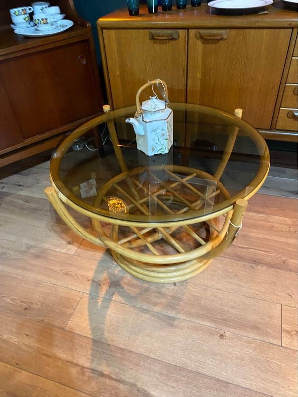 Round vintage bamboo coffee table with a smoked glass top