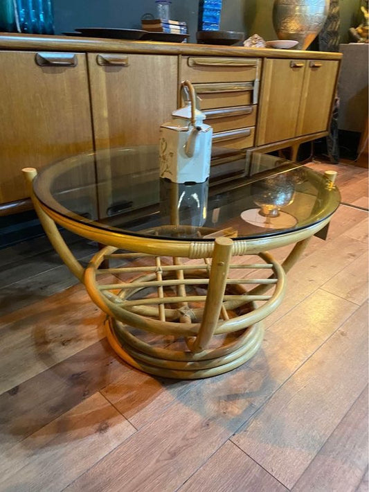 Round vintage bamboo coffee table with a smoked glass top