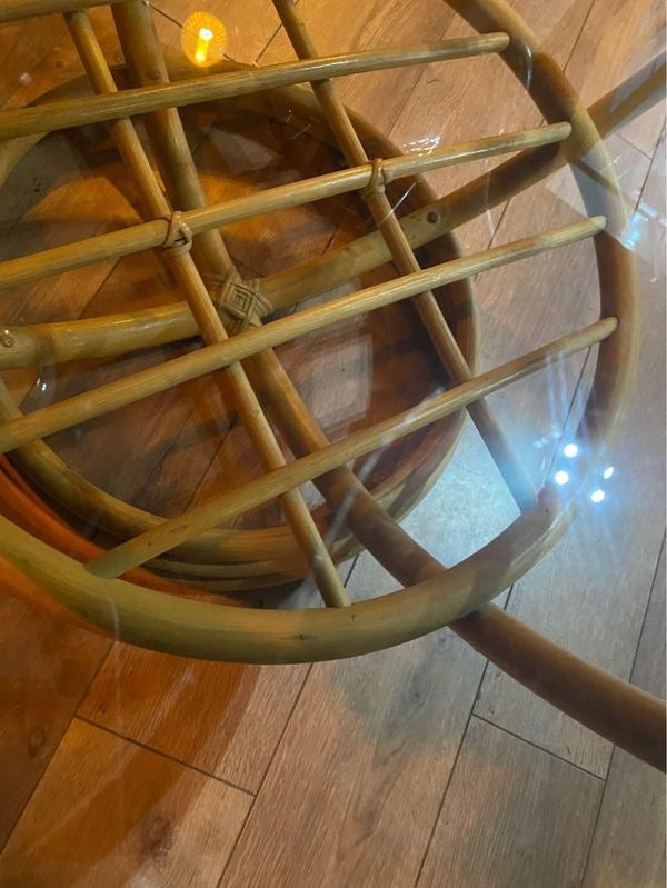 Round vintage bamboo coffee table with a smoked glass top